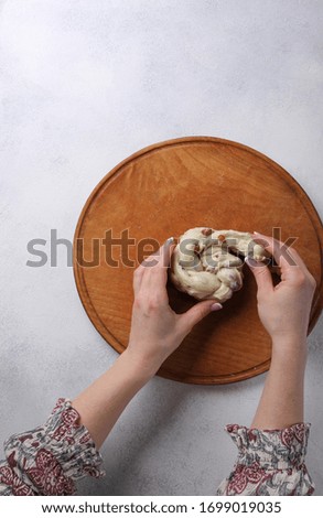 The process of cooking with hands. Preparation. Wooden board with dough on a white background. Top view. Kitchen. Culinary. Background image, copy space