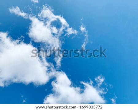 Blue sky with white clouds background image look like angle or girl try to help the dog