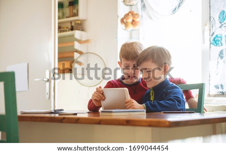 Boys Playing With Digital Tablet At Home