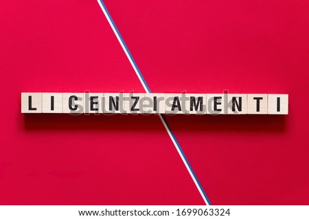 Licenziamenti - layoffs in Italian word concept on cubes