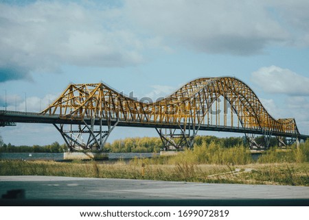 A bridge across a yellow river in the shape of a dragon. A bridge across the north river.