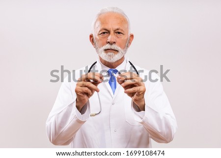 Senior doctor showing broken cigarette.Stop smoking concept.