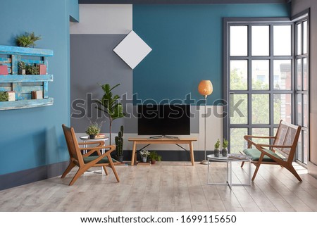Decorative blue living room style with wooden furniture, chair carpet and hang. Vase of plant style.