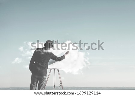 surreal man painting cloud on canvas, creativity concept Royalty-Free Stock Photo #1699129114
