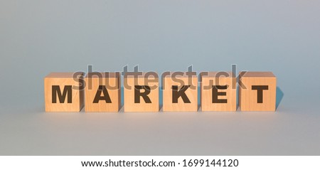 light wooden cubes with the inscription of the market on a gray background
