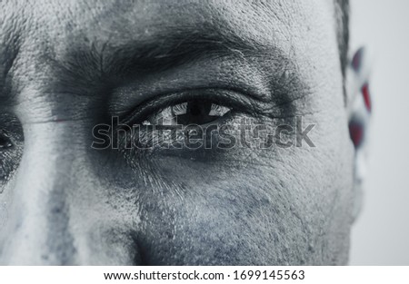 eyes, man staring and focus on camera. close-up with bristles on a gray background. male eyes close-up. Royalty-Free Stock Photo #1699145563