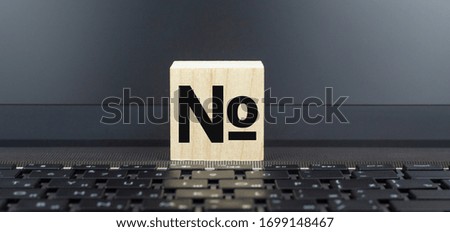 Wooden cube on Computer Keyboard