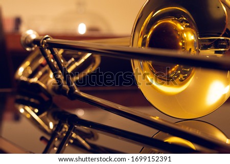 closeup of tenor trombone on the table Royalty-Free Stock Photo #1699152391