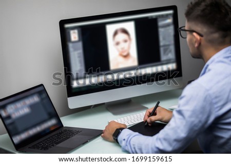 Close-up Of A Designer's Hand Editing Photo On Computer In Office