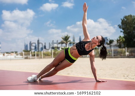 Fitness woman strength training her body core muscles with yoga pose.