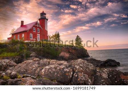 Sunset and clouds at the Eagle Harbor Lighthouse on the Keewenaw Peninsula. Royalty-Free Stock Photo #1699181749