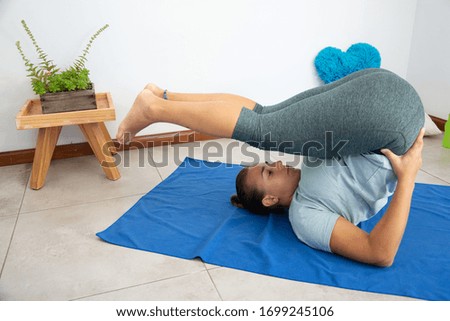 Woman doing exercises at home during quarantine.