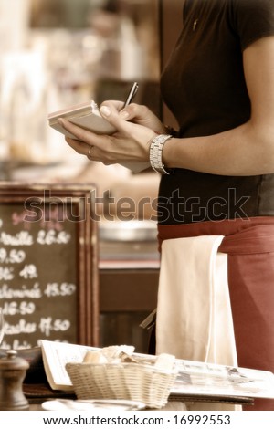 Toned outdoor cafe scene with waitress taking order Royalty-Free Stock Photo #16992553