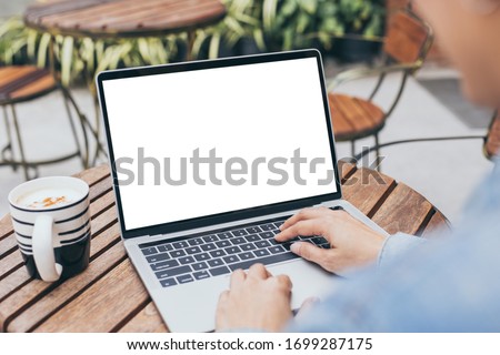 computer mockup image blank screen with white background for advertising text,hand woman using laptop contact business search information on desk at coffee shop.marketing and creative design Royalty-Free Stock Photo #1699287175