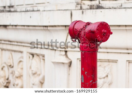 Photo of old red metallic fire hydrant plug