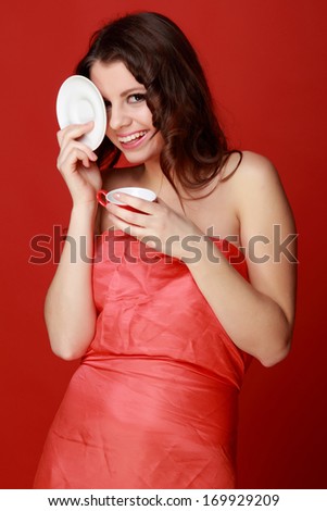 Smiley woman with red cup of coffee