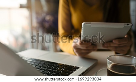 Work from home people using tablet and laptop online social network communication,Interior home blurred background.- Image