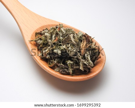 High angle view of dry mugwort on spoon isolated on white background. Chinese herbal medicine. Be used to ward off evil spirits and to drive away mosquitoes during the Dragon Boat Festival in Taiwan.