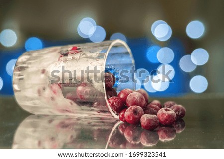 Frozen cherry in the glass reflecting on the surface. blurred background selective focus 