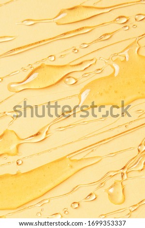 Background of melting honey on a yellow background, spreading honey place for text, drops, texture