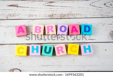 "a broad church "-the words on wooden cubes.  A background image of english words on colorful building blocks.