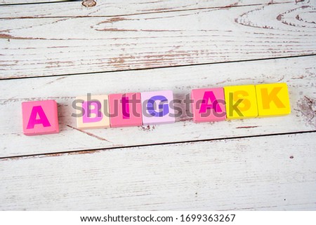"a big ask "-the words on wooden cubes.  A background image of english words on colorful building blocks.