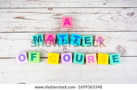 "a matter of course"-the words on wooden cubes.  A background image of english words on colorful building blocks.