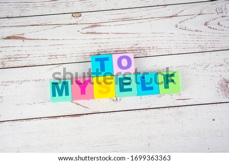"to myself"-the words on wooden cubes.  A background image of english words on colorful building blocks.