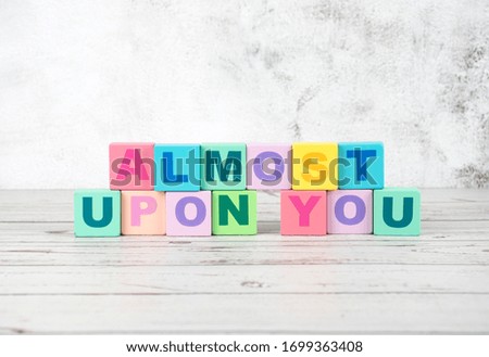 "almost upon you"-the words on wooden cubes.  A background image of english words on colorful building blocks.