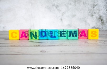 "candlemas"-the words on wooden cubes.  A background image of english words on colorful building blocks.