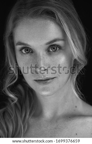 Black and white professional portrait with a beautiful woman in a photo studio.