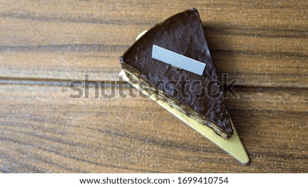 Almond chocolate cake isolated on wooden background
