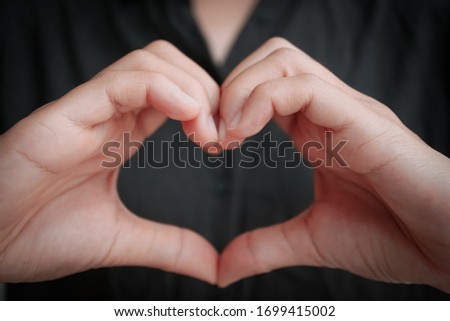 Woman hand do heart shape metaphor love and care background.