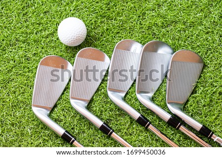 Top view different golf club and golf ball on green grass background.Golf sport equipment.Outdoor sport.