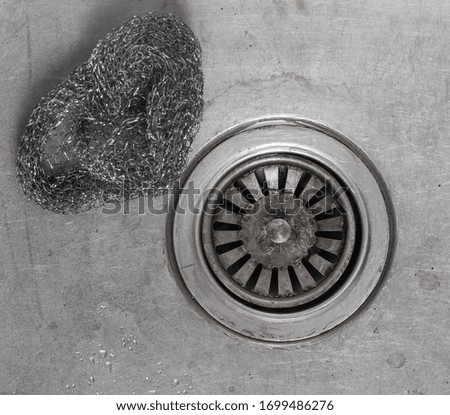 isolated steel  drain for water in the kitchen sink