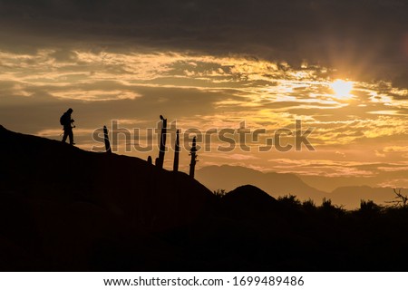 photographer walking in the desert 
