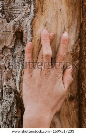 Man's hand with twisted fingers on a wooden background