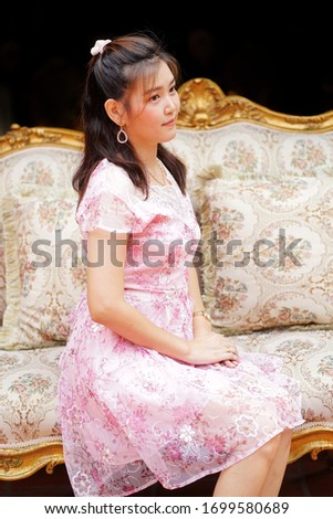 asia woman is sitt​ing​ on sofa​ very​ beautiful​