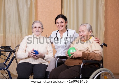 couple of senior Woman with physical therapists using fitness balls