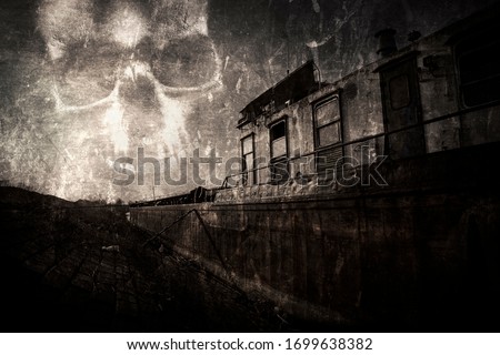 Ghost ship. Haunted ,abandoned shipwreck stranded at the river bank. Scary evil skull in the sky. Vintage, worn and scratched film look Royalty-Free Stock Photo #1699638382