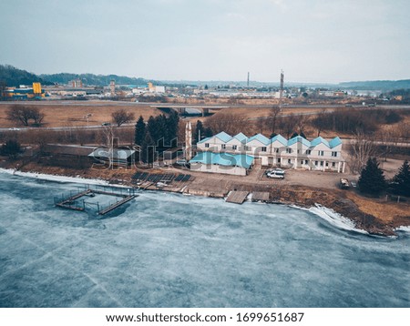 Drone aerial view of frozen lake in Kaunas, Lithuania