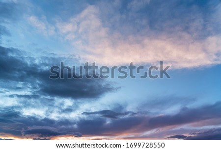 Beautiful colorful blue sunset sky with orange clouds. Nature sky background.