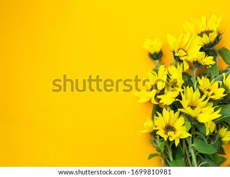 Yellow bouquet with a sunflower on a yellow background. Bright banner for the autumn sale, harvest festival or Thanksgiving. Top view composition, copy space