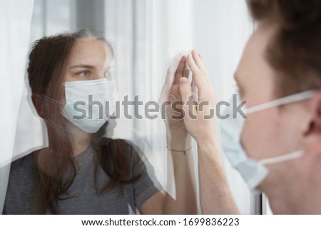 Quarantine. Coulpe Touching Each Other Through Glass. Lockdown Concept, CoVid-19. Royalty-Free Stock Photo #1699836223