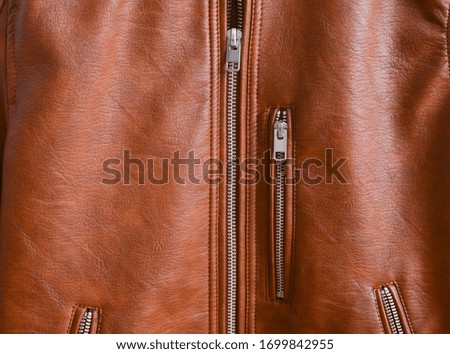 metal zipper on a brown jacket texture