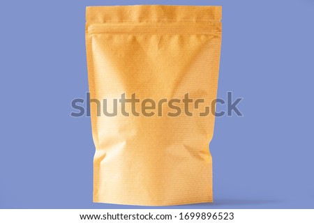 brown striped paper doy pack stand up bio pouch with zipper on blue background Royalty-Free Stock Photo #1699896523