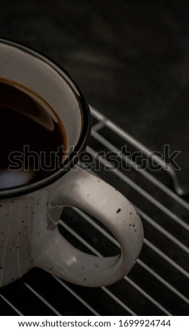 In a coffee mug on a background of coffee grains