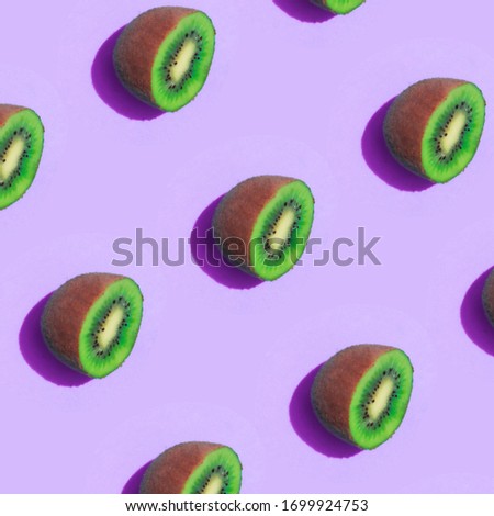Image of a pattern of kiwis on a violet background