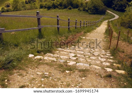 Narrow path leading down among the mountains. France. Montségur and mountains view. Summer. 