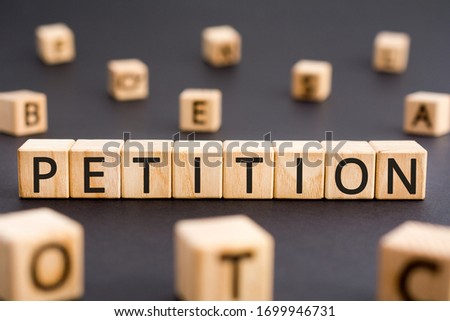 Petition - word from wooden blocks with letters, a formal request petition concept, random letters around black background Royalty-Free Stock Photo #1699946731